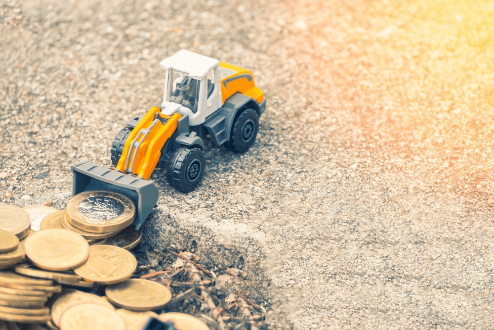 close-up-toy-bulldozer-by-coins_1048944-5352860